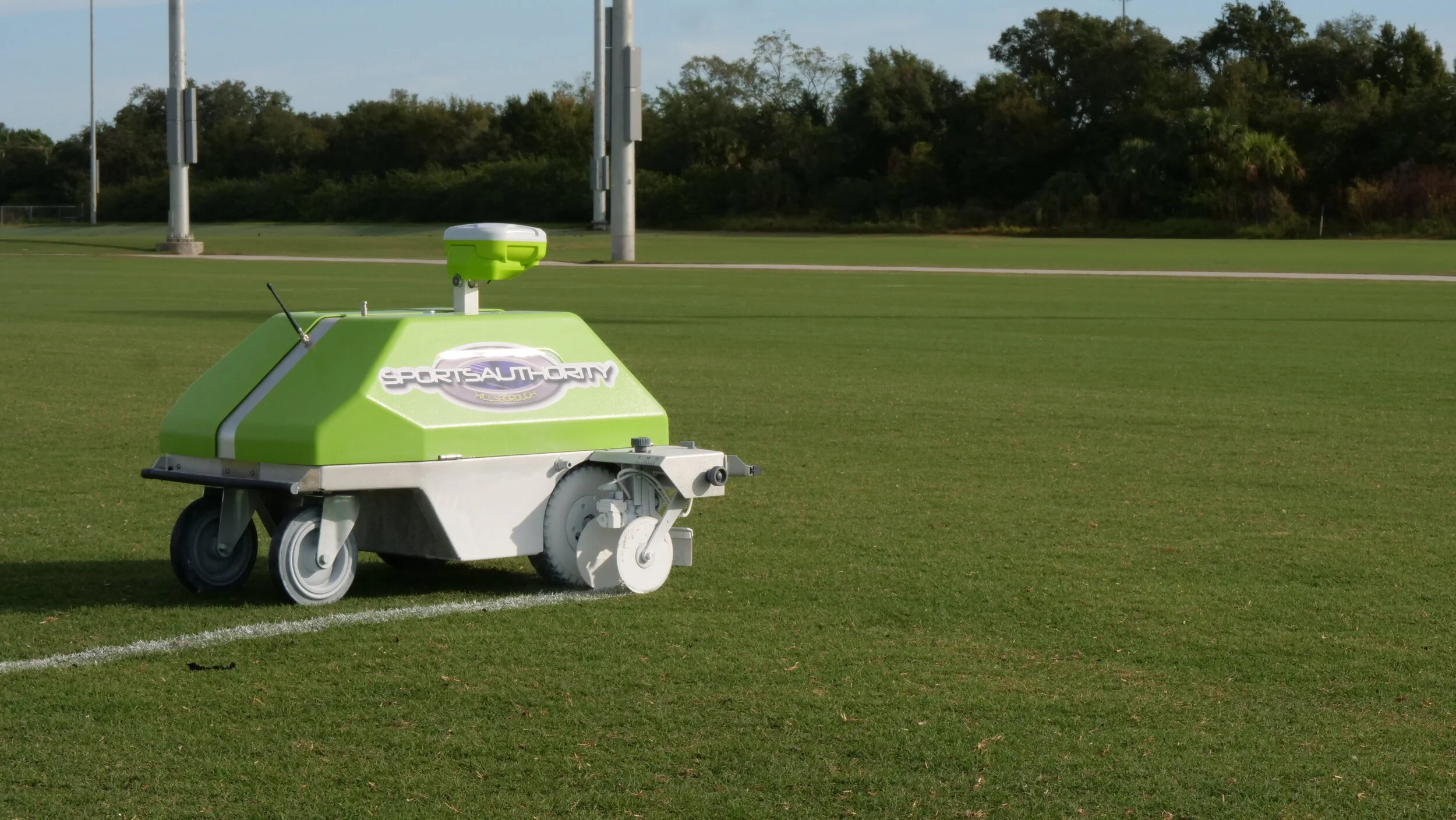 The Sports Authority logo is seen on a chalk lining machine on a field. 