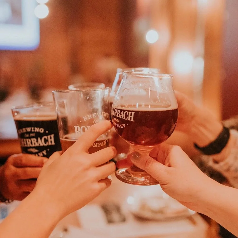 People cheers-ing Rohrbach beer glasses