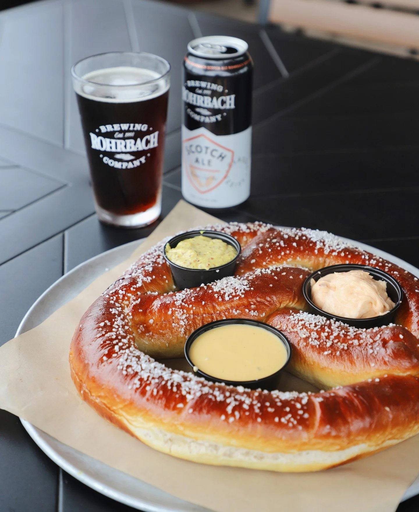 The only thing better than a giant pretzel is a giant pretzel that's part of a happy-hour deal. 🥨⁠
⁠
Swing by the Buffalo Rd. Brewpub Monday&ndash;Thursday [2pm&ndash;5pm] for $1 off drafts and select snacks and shares. A very good reason to clock o
