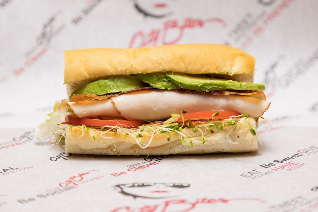   California Club   Turkey breast, bacon, provolone, avocado, alfalfa sprouts, lettuce, tomatoes, mayo, blended oils, salt &amp; pepper. 