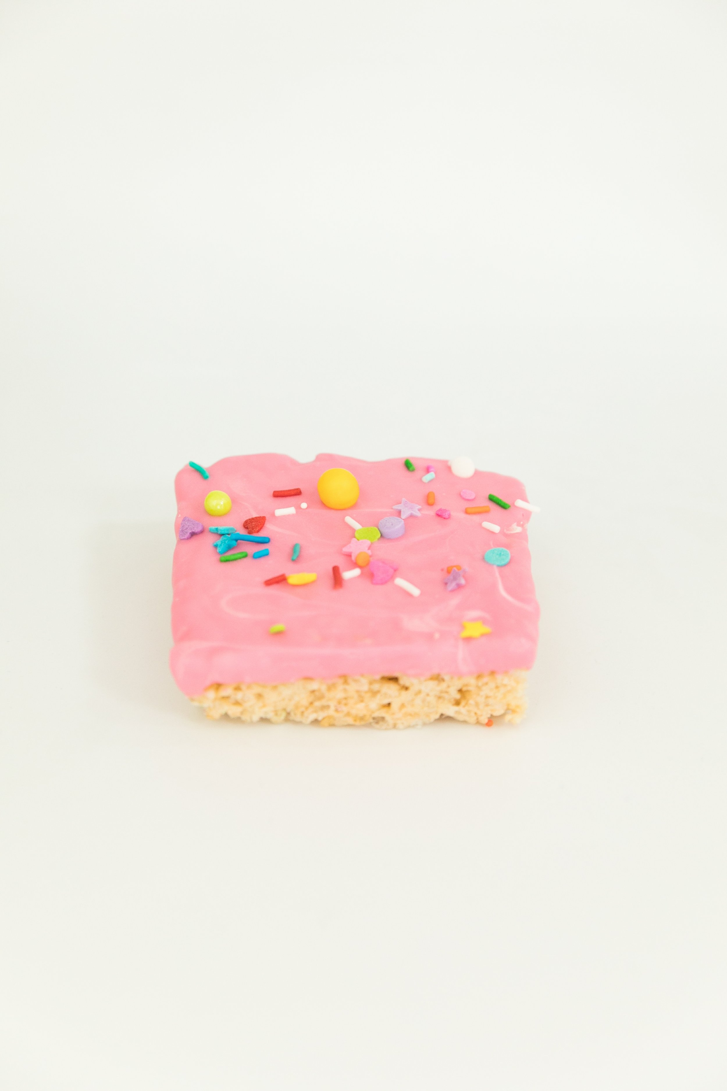  rice krispies treat dipped in pink white chocolate with sweetapolita sprinkles  