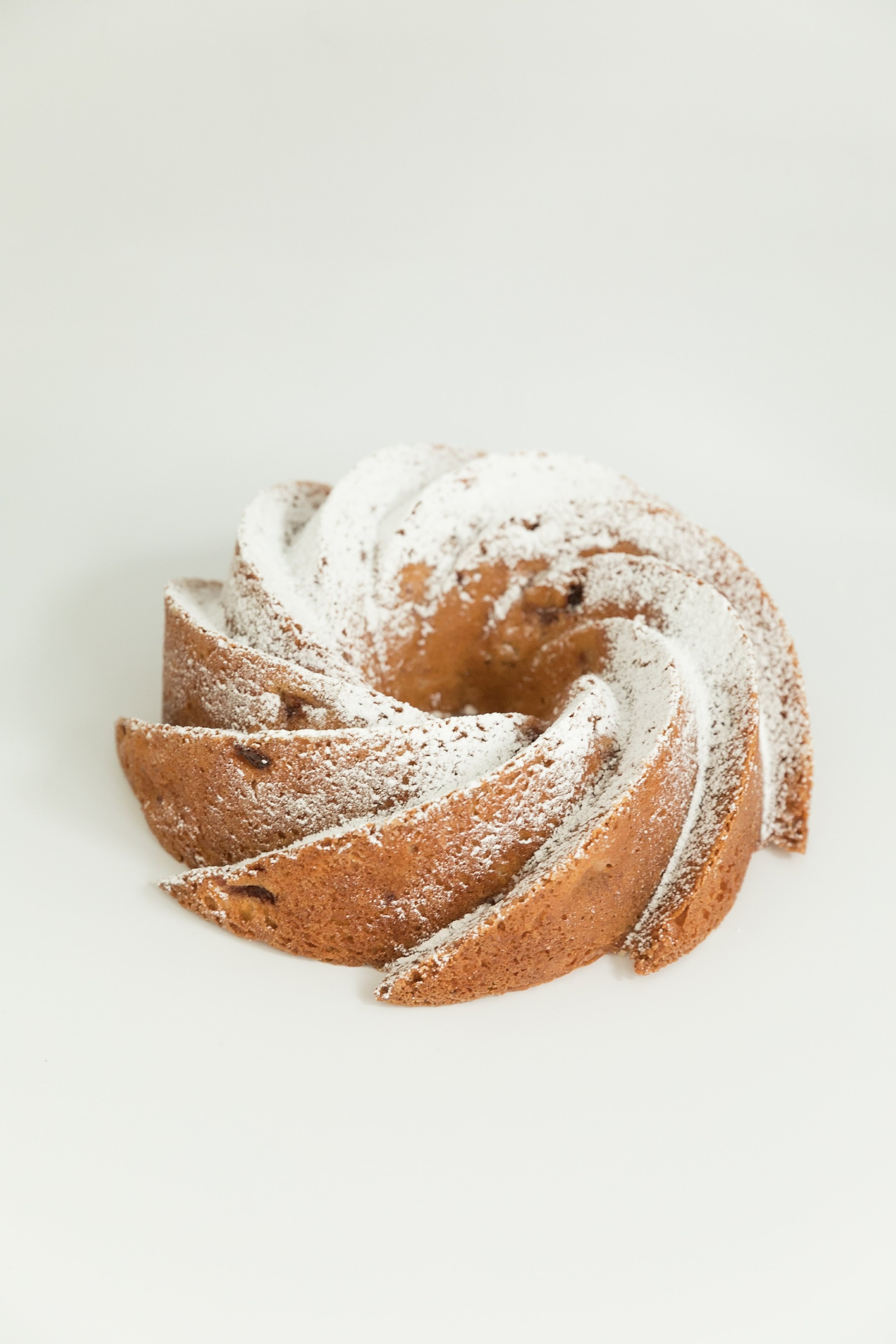  strawberry bundt cake topped with a light dusting of powdered sugar 