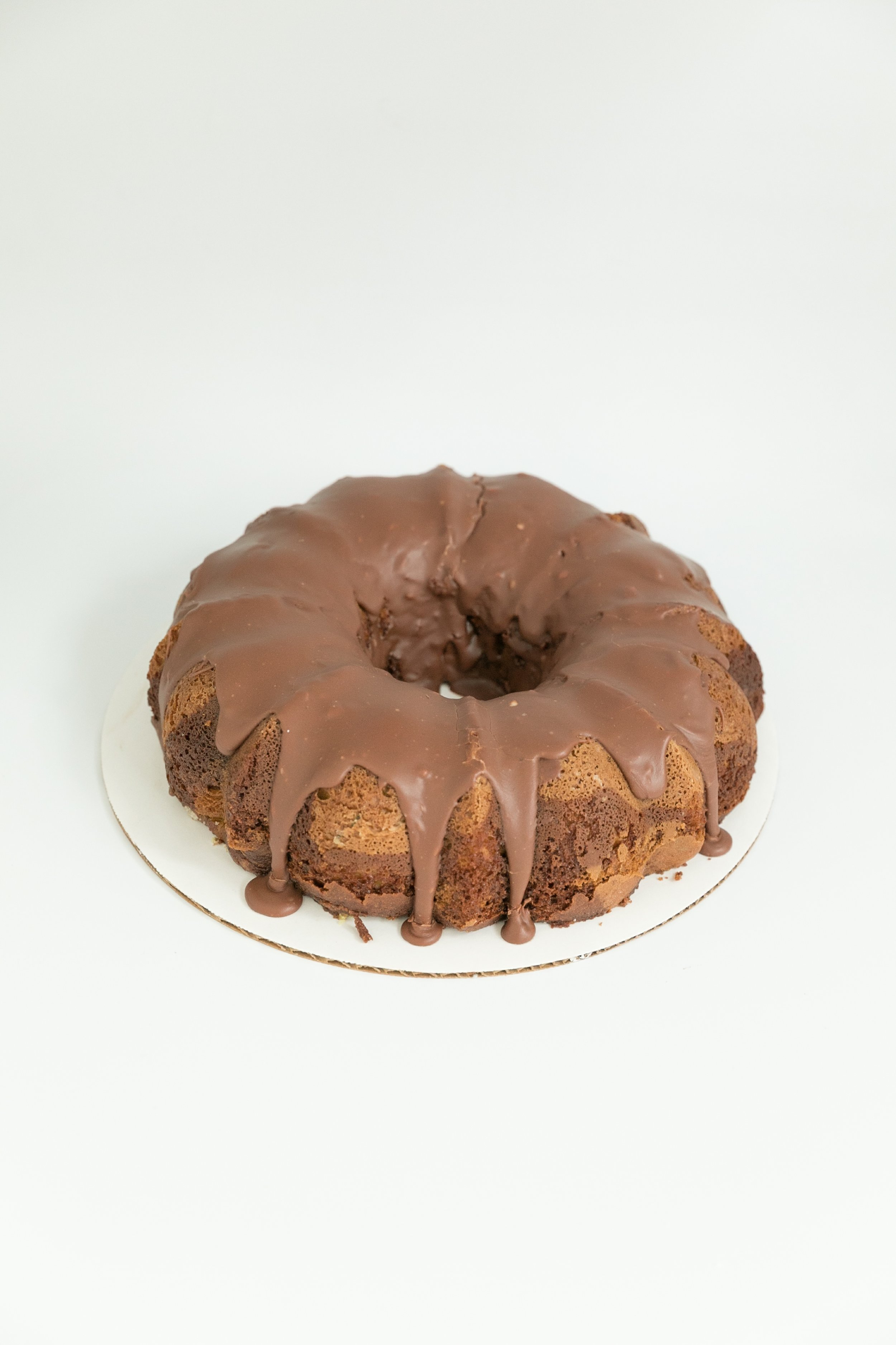  Old-fashioned pistachio bundt cake topped with a chocolate ganache. 