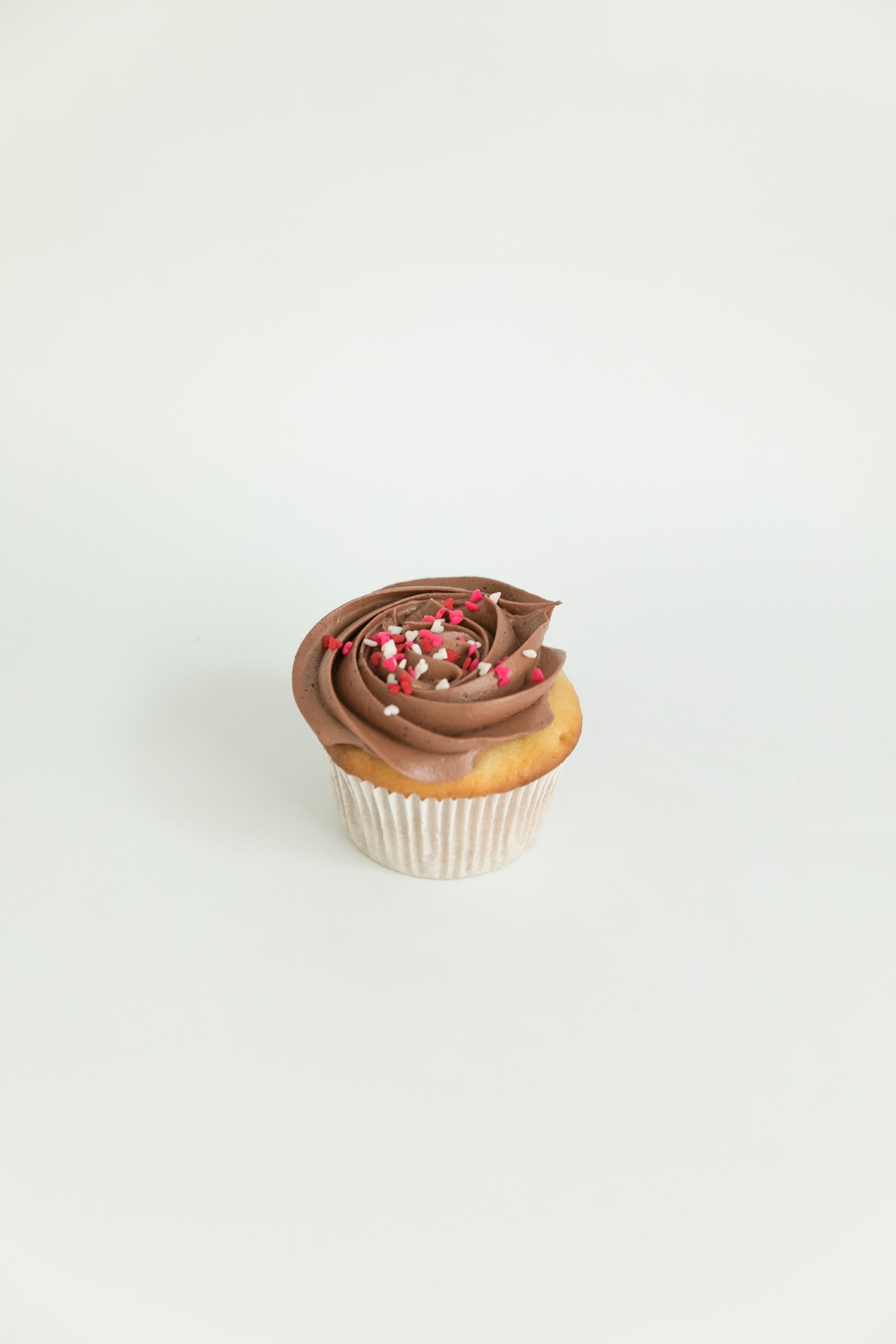  Vanilla cupcake with chocolate buttercream and heart sprinkles  