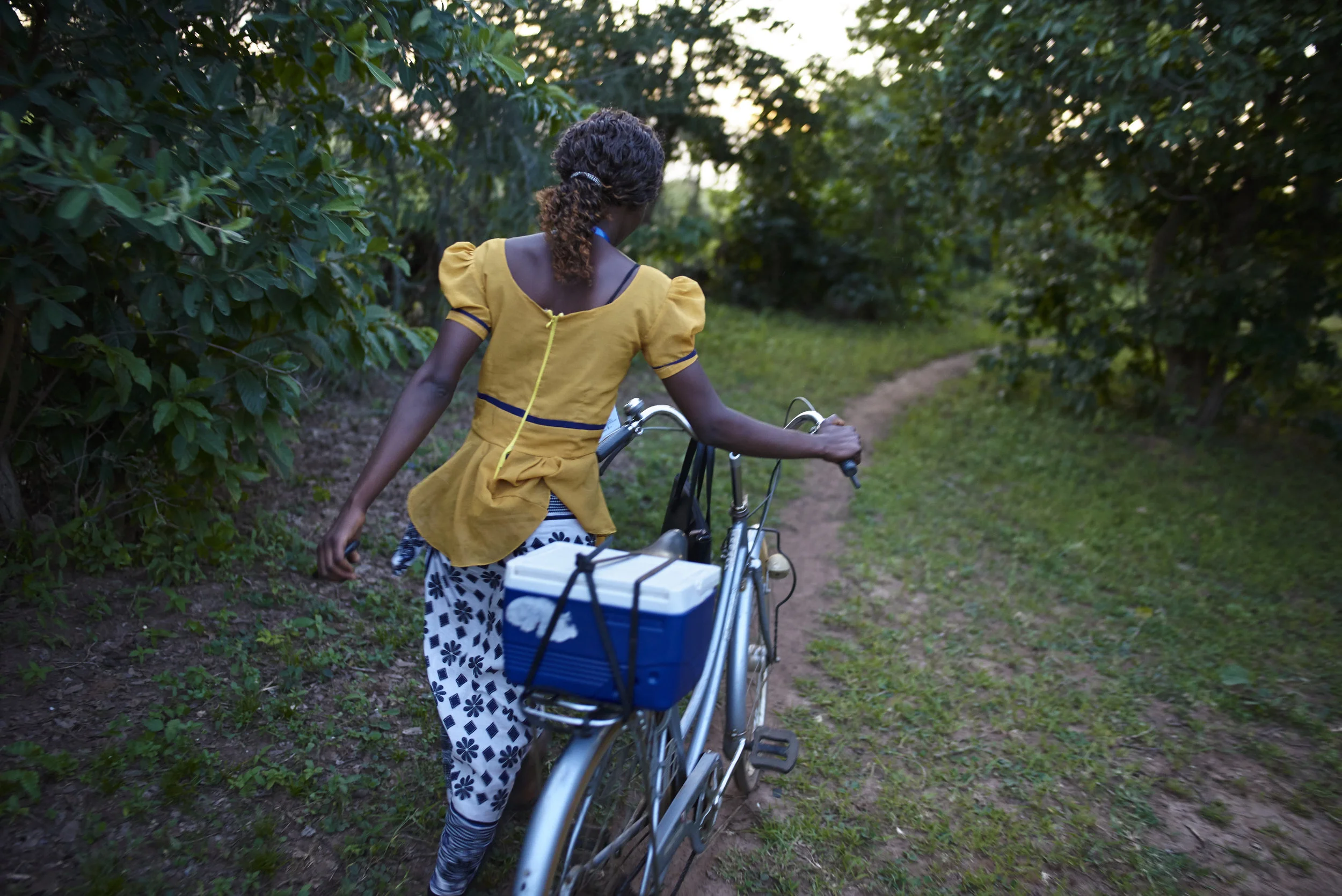 Community Health worker carrying a sputum collection container during screening and linkage activities within the community