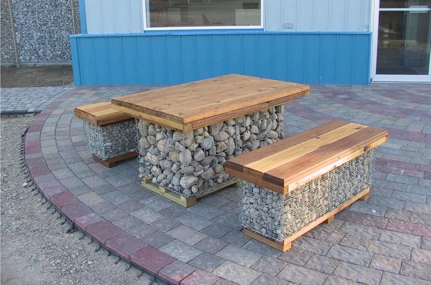 Use rock-filled gabion baskets with wooden slabs on top to create an outdoor table and bench set