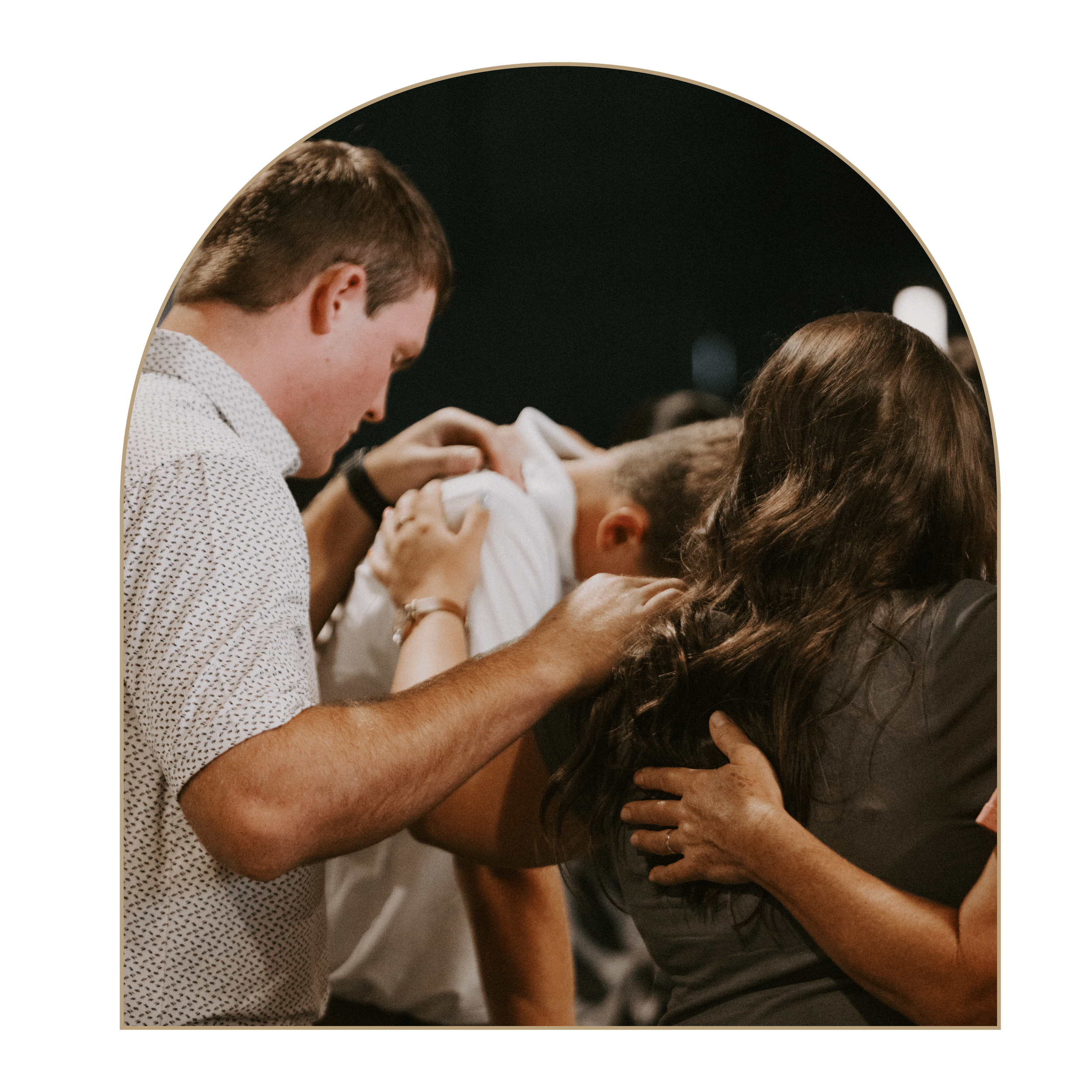 A group of diverse people holding hands tightly together in unity, suggesting a moment of prayer, meditation, or mutual support.