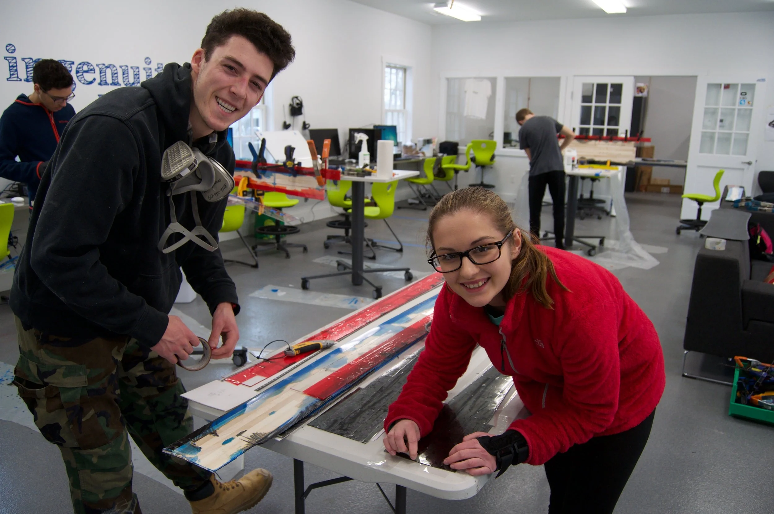 Andre and Maya adhering packaging tape to base to help protect base durin glay-up frmo epoxy