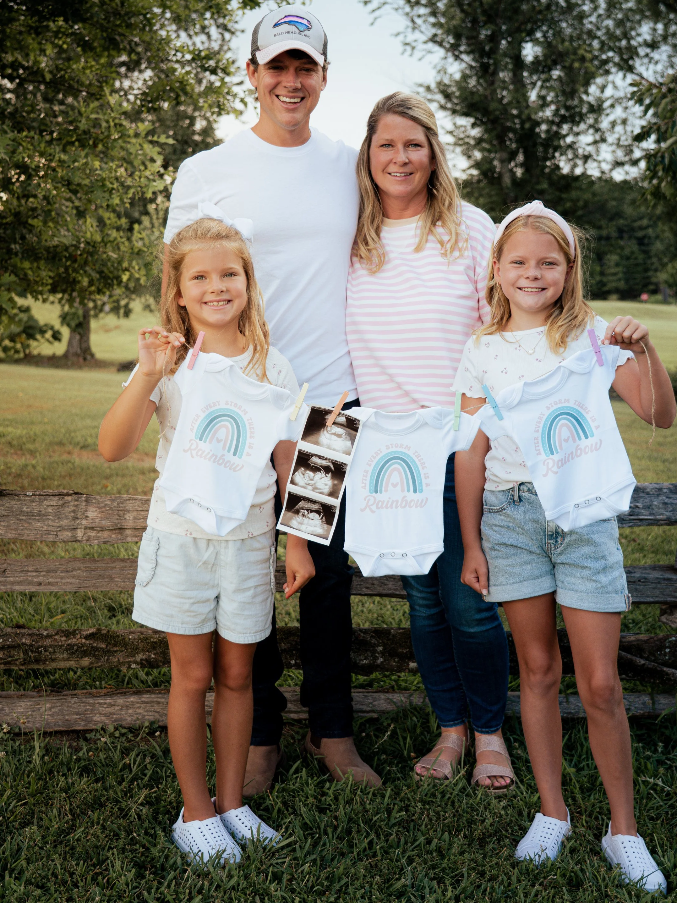 Dusty Porter with his wife and two daughters holding ultrasound photos