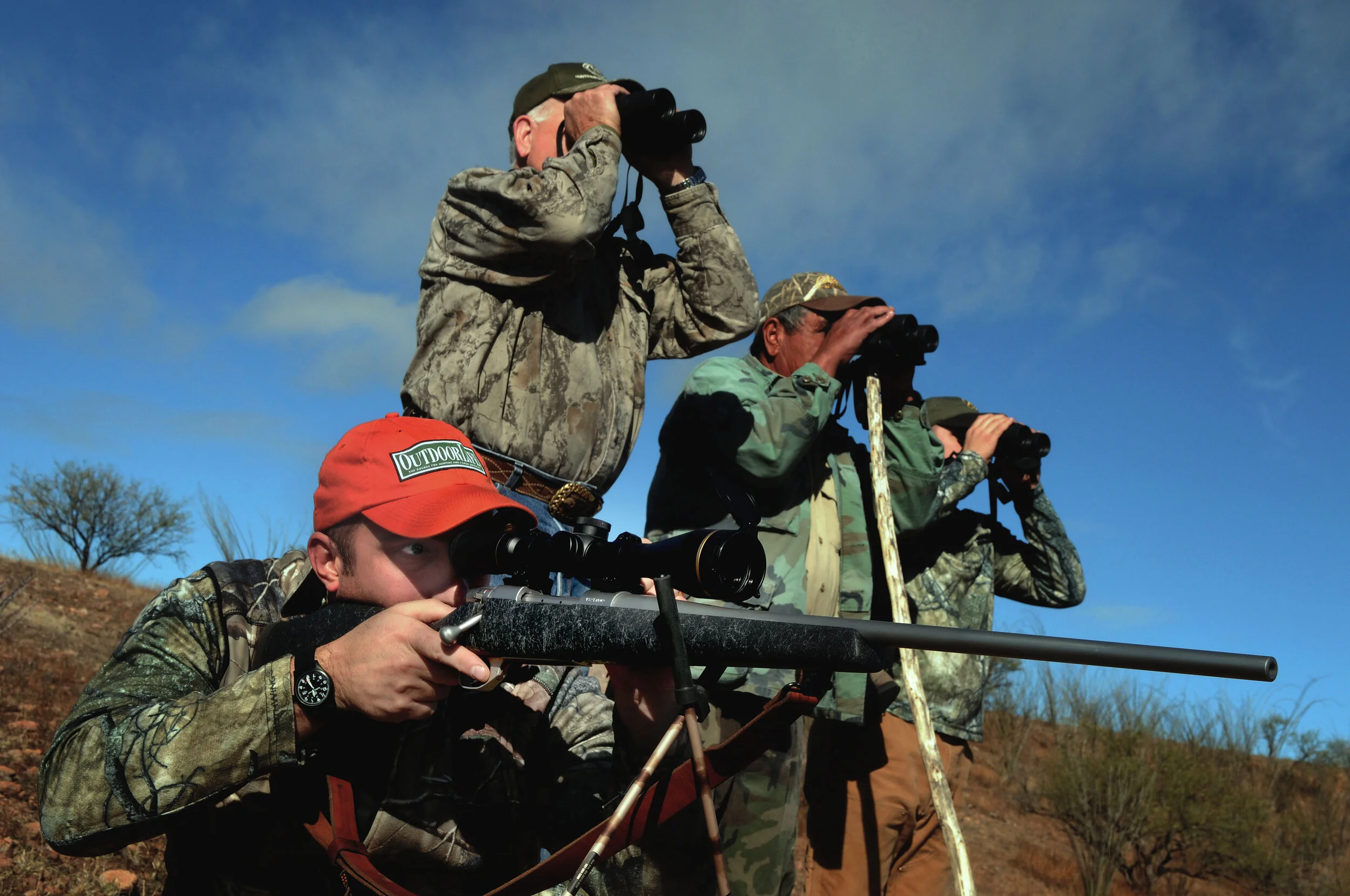 three binos and a rifle light.jpg