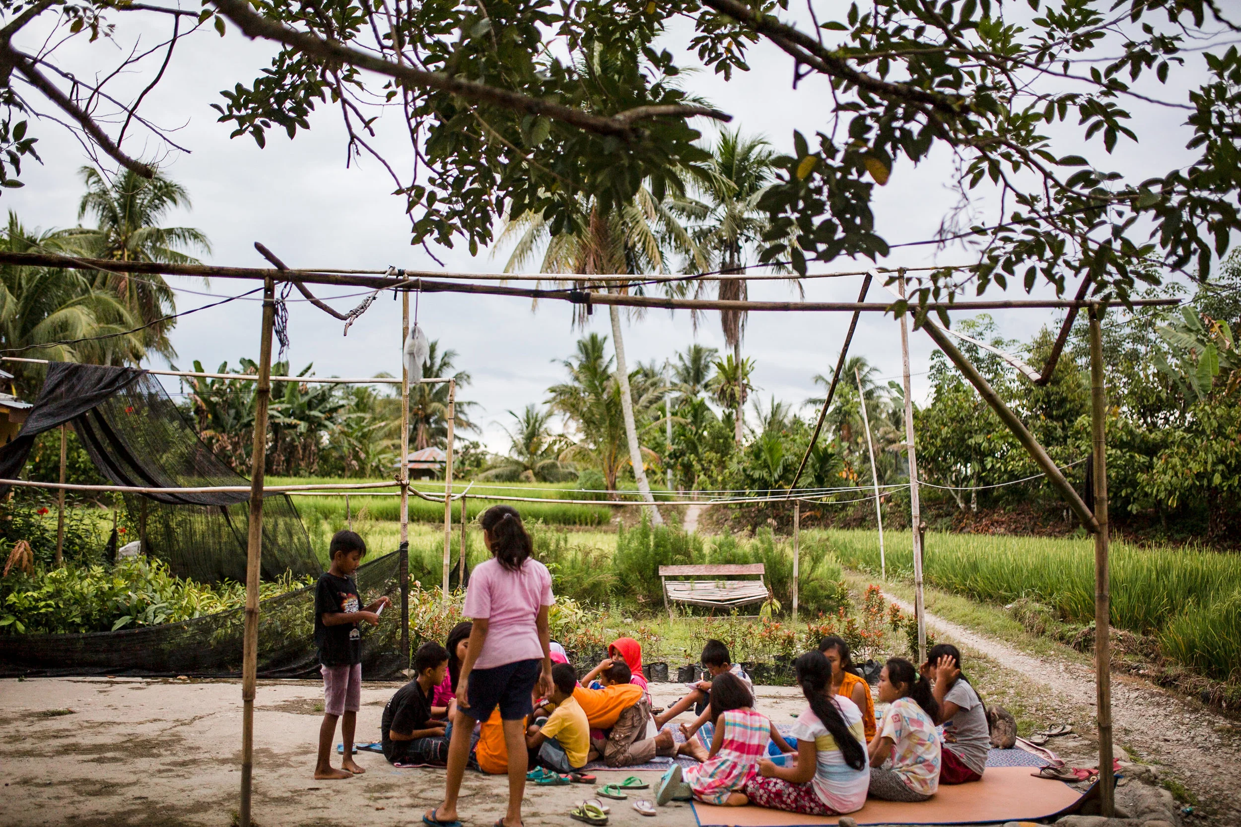 Taking advantage of a rain-free day, children practice their English skills outside of the Rumah Baca Pintar Bersama school in the village of Timbang Lawan, located just outside of the Gunung Leuser National Park.