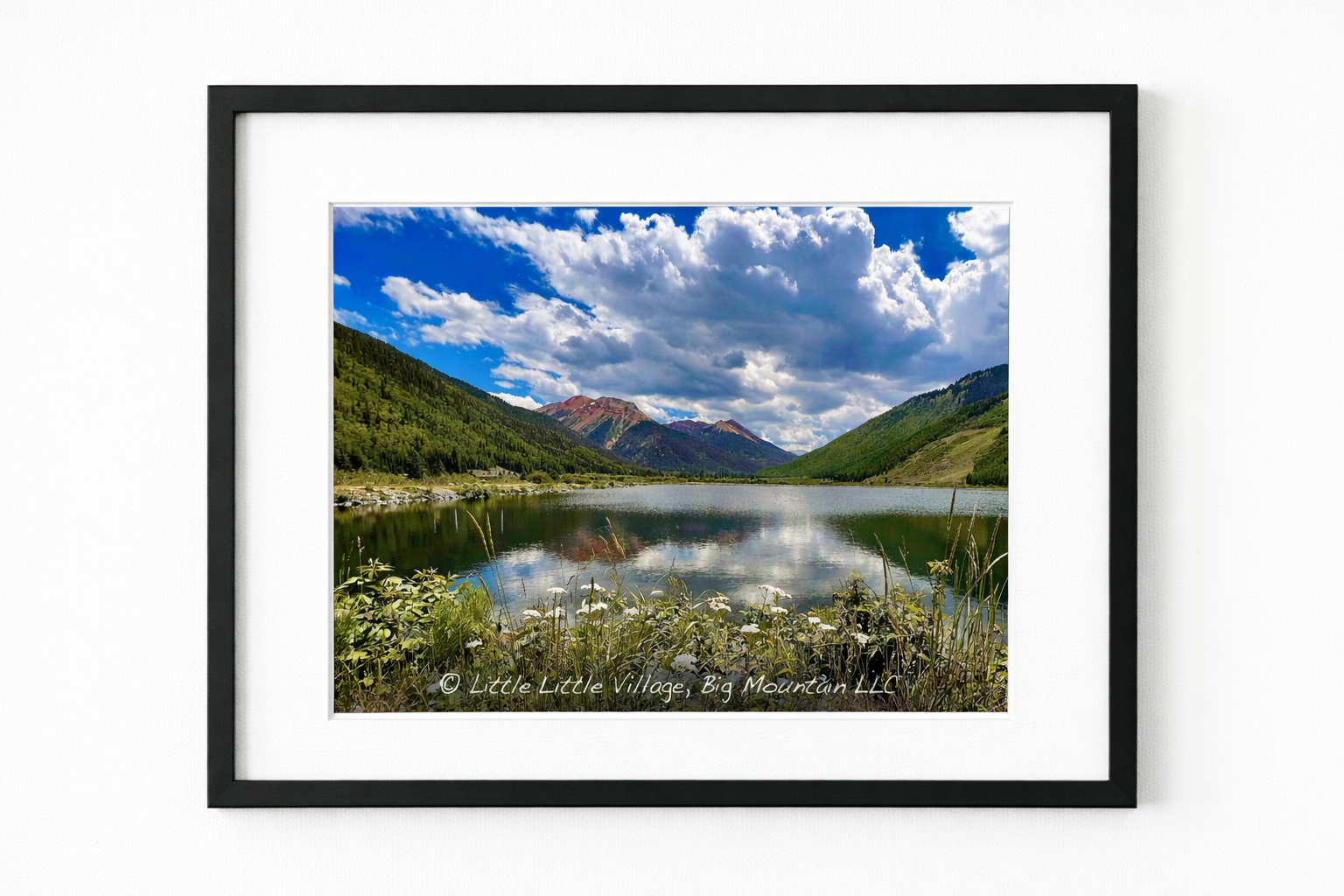 Serene alpine lake with vibrant peaks.png