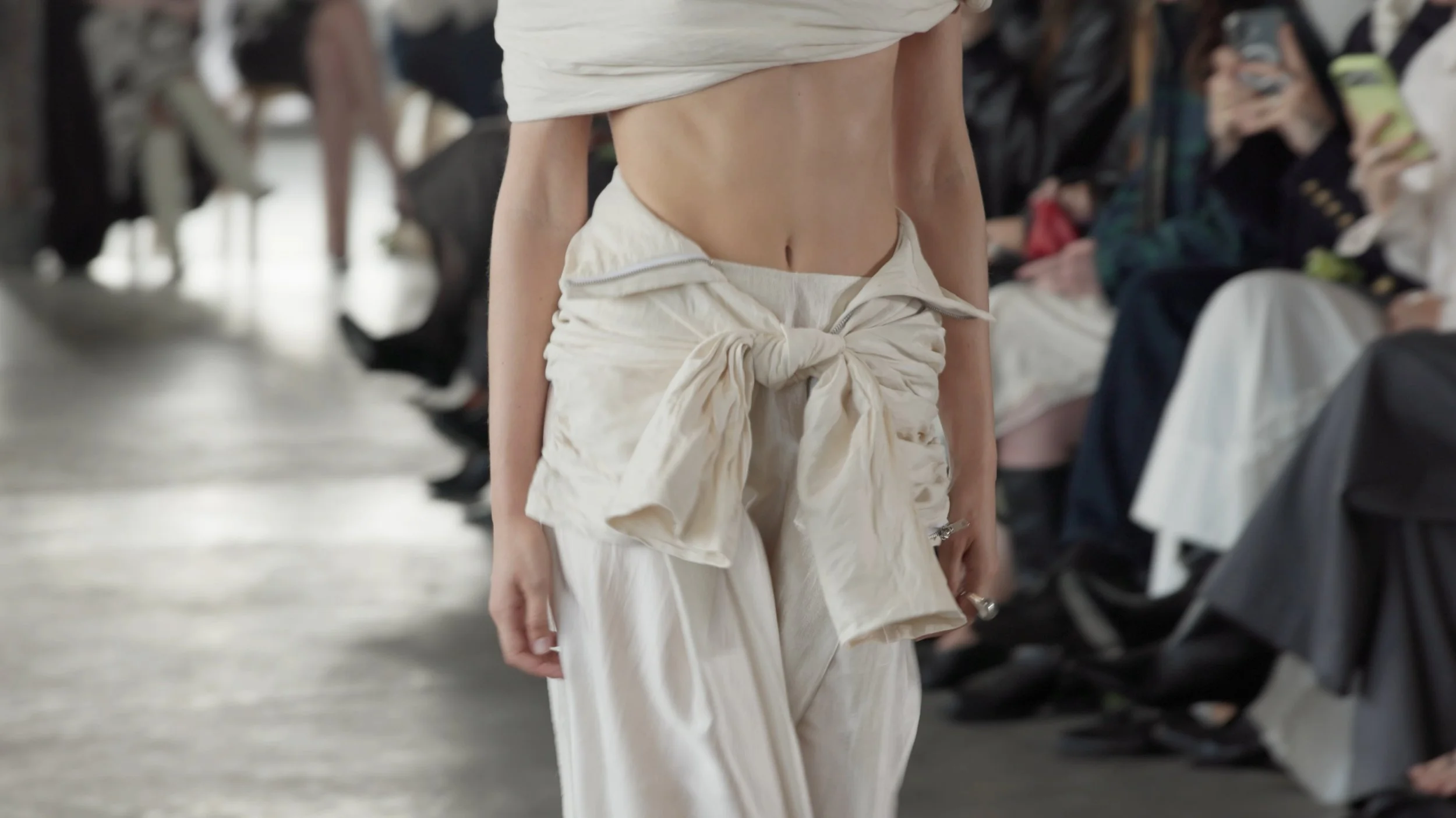Detail shot of avant-garde fashion styling and textiles from an AFW runway presentation.
