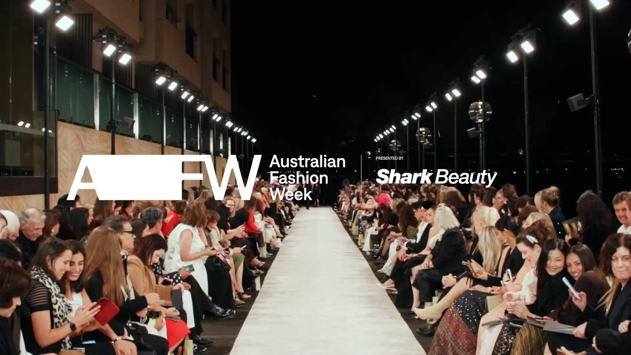 ide angle fashion runway cinematography showcasing the Australian Fashion Week AFW crowd and overhead lighting design