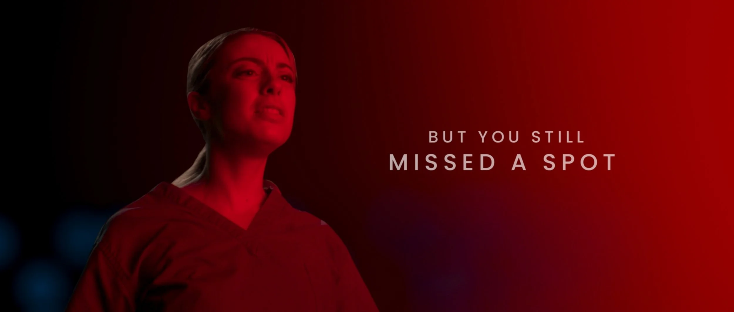 Healthcare worker lit in red reacting within a simulated medical environment during VFX-heavy Nanosonics commercial