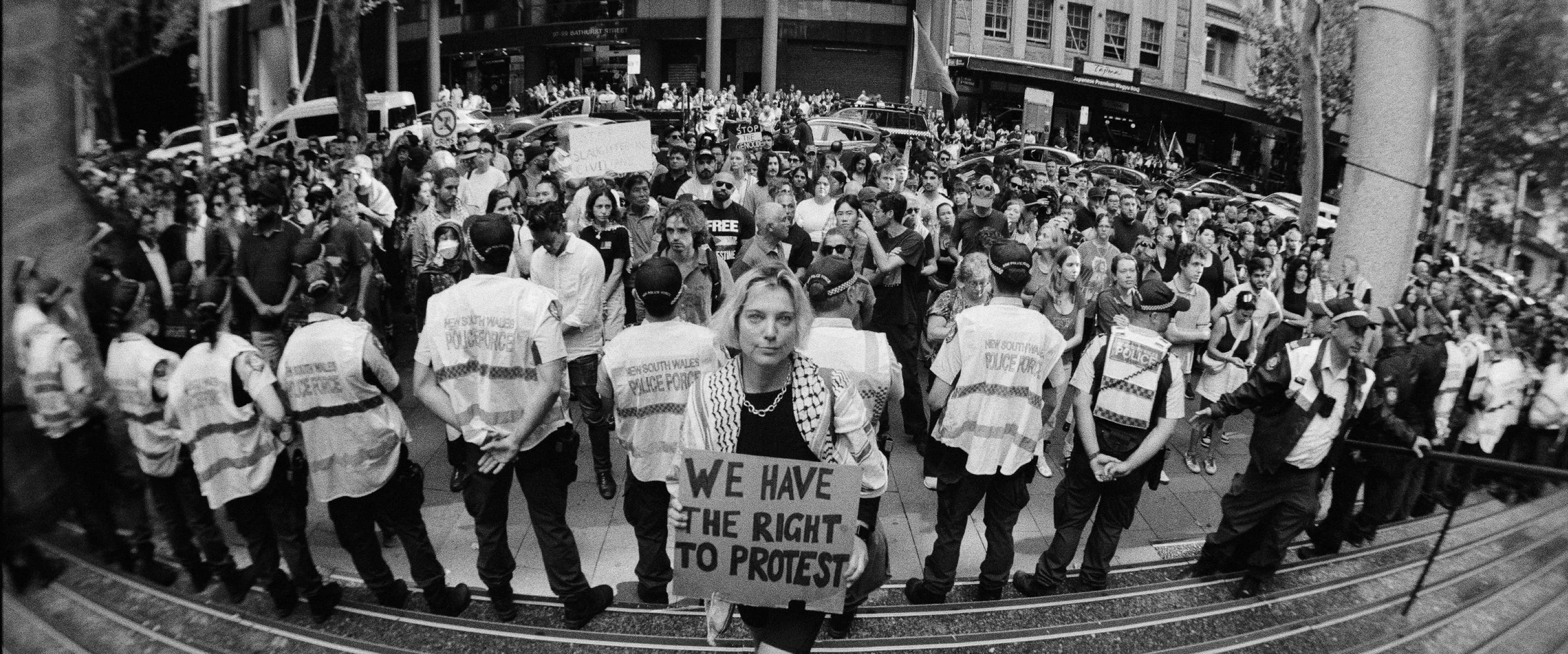 Woman displaying sign reading we have the right to protest, at the protest against Isaac Herzog’s visit to Australia — photographed by Elliott Deem.