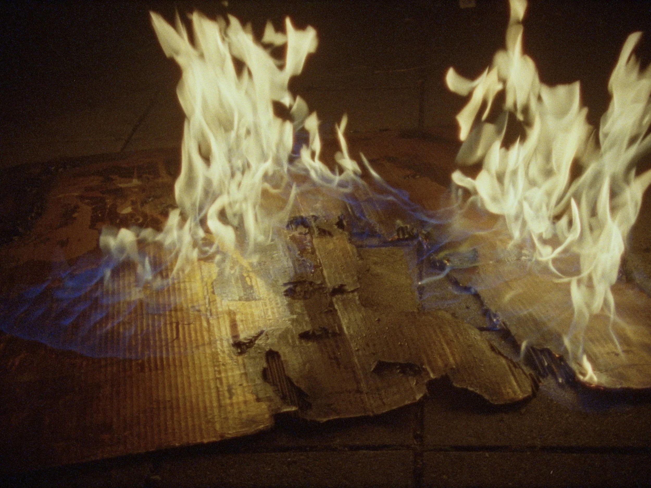 Controlled use of fire in Lachlan Warner’s art practice, cinematic documentary still by Elliott Deem