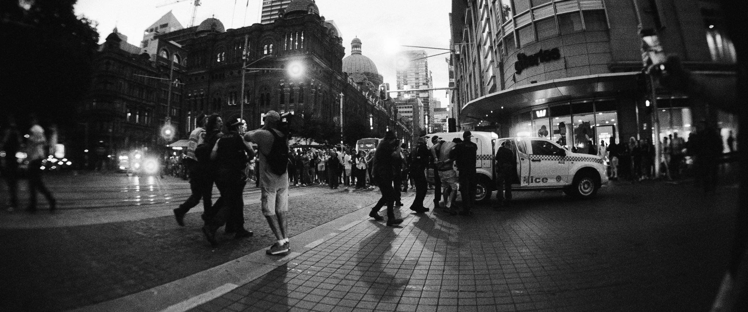 NSW Police officers detaining a protester during a demonstration in Sydney opposing the Australian visit of Israeli President Isaac Herzog — documentary photography by Elliott Deem.