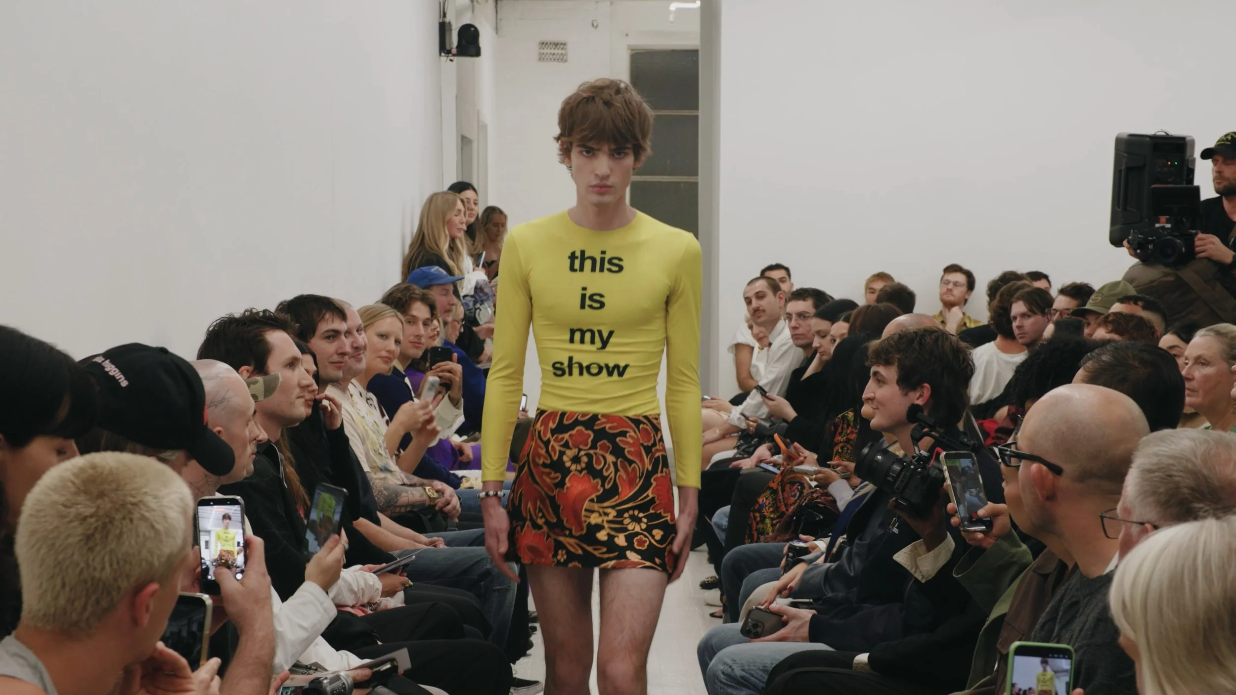 Runway look featuring graphic yellow long sleeve top at Australian Fashion Week.