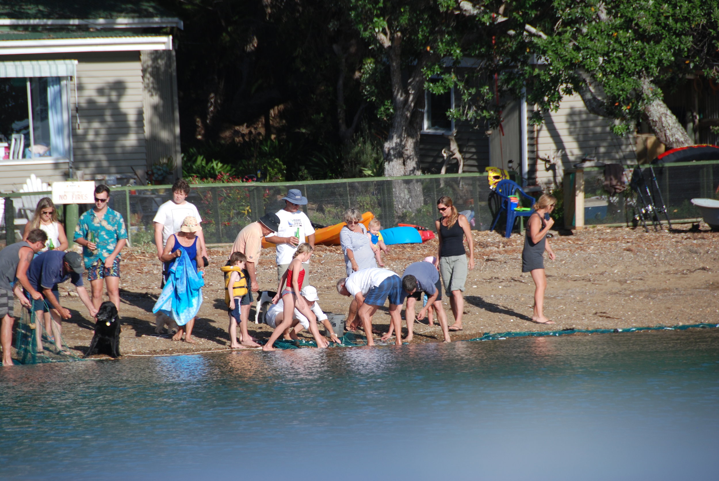 Family beachside fishing on Kawau Island