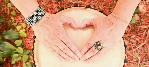 Tara Cindy Sherman’s hands form a heart on the head of her Djembe drum.