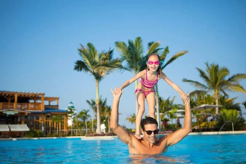 Dad and daughter enjoying pool time on Harvest Cay Belize (c) NCL