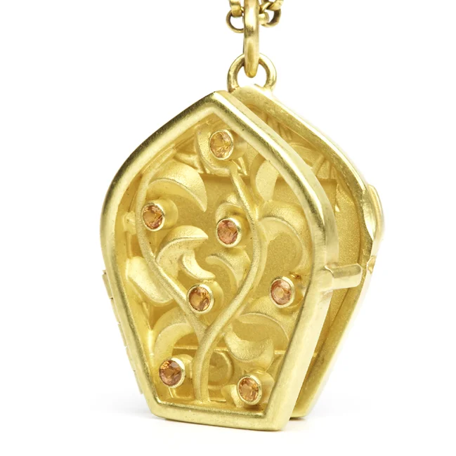 Which of your beloveds would earn a spot in this locket, next to your heart? Glimpses of the photo coyly peek out, as if from an intricately carved window in an ancient city.