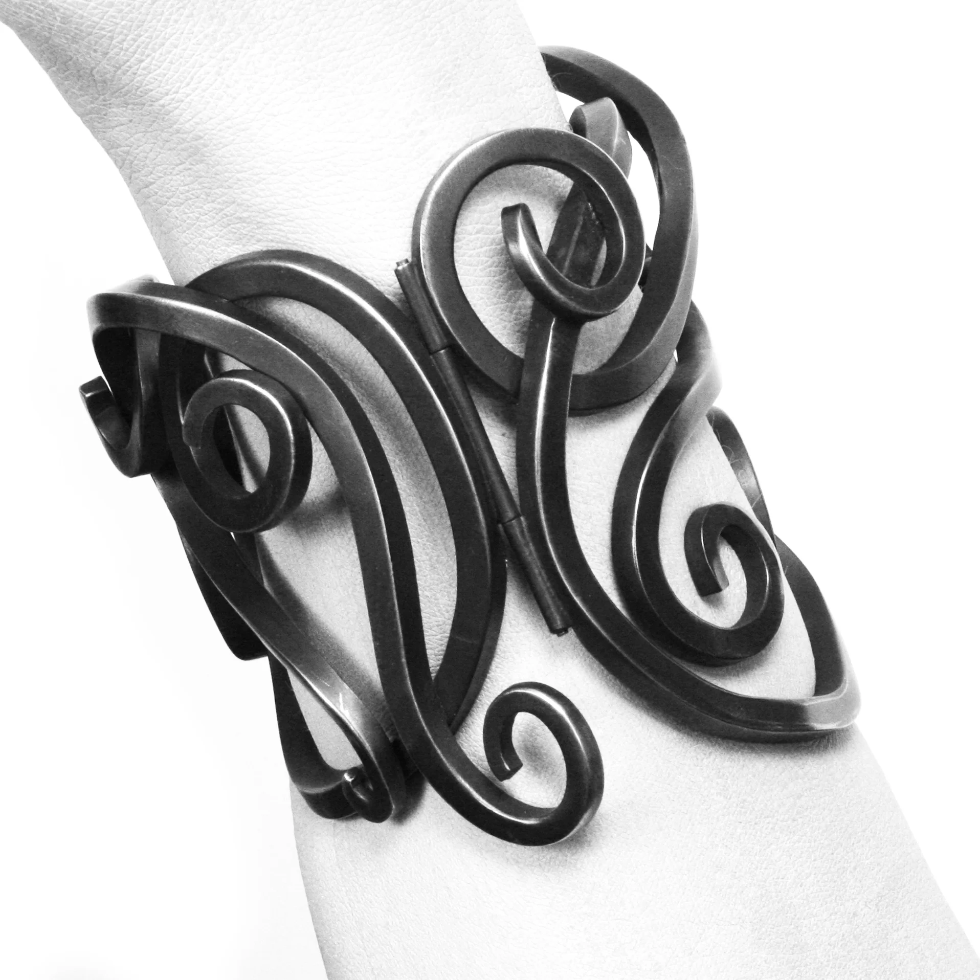 Armored up, beautifully. It’s heavy, you definitely won’t forget you are wearing it, and nobody who meets you will fail to notice. The love child of an Art Nouveau master and the local blacksmith, in silver, which has been subversively blackened.