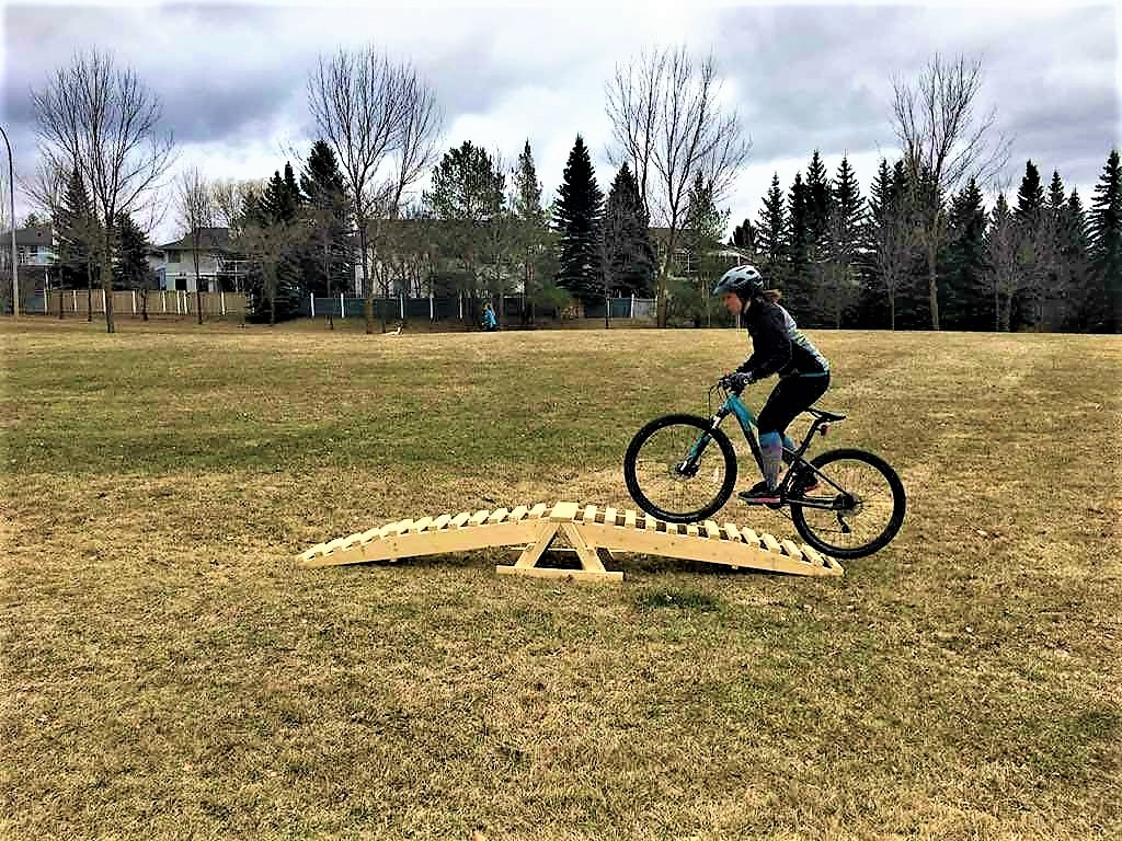 Katie pedals over a rounded a-frame. Eyes up, body strong and balanced! Photo cred: Cranky’s Women’s MTB Club
