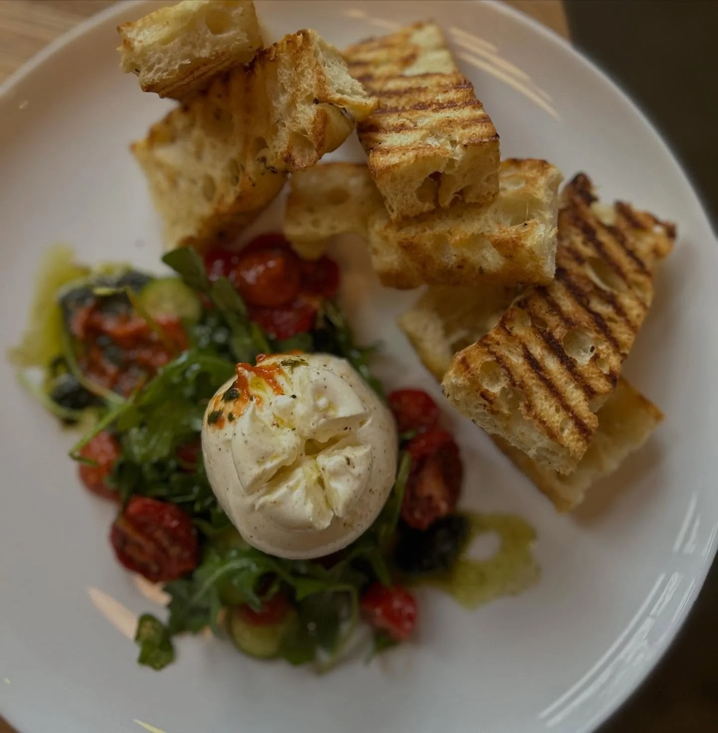 Winter menu launches today! 

Starting off with our Fresh Burrata, Winter Caprese - oven dried vine ripe tomato, tomato conserva, pesto, balsamic crema, arugula and house made focaccia 🤍