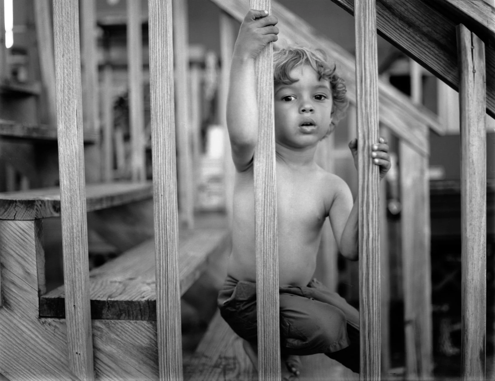 Beach Kid Behind Wooden Slats