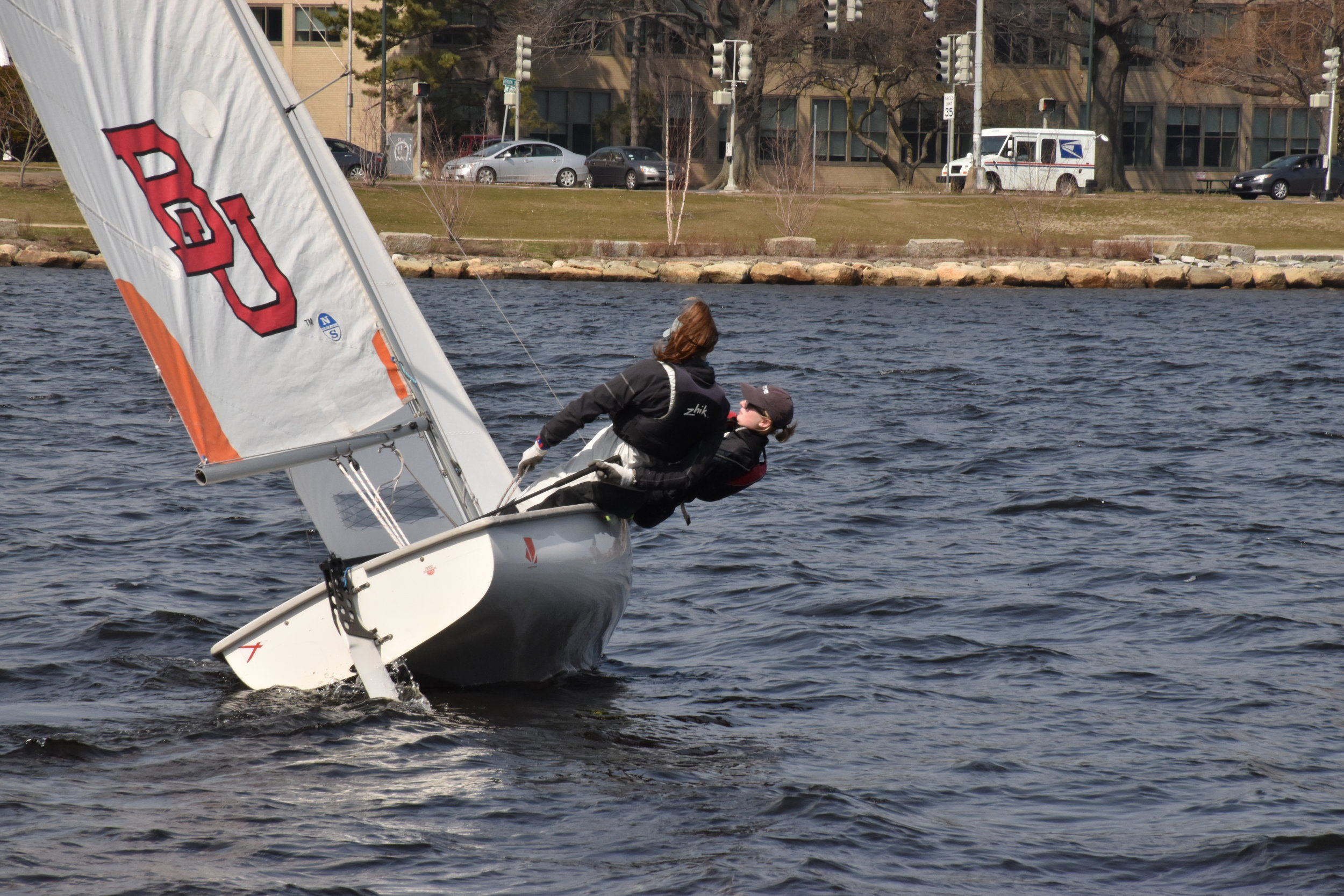 Two members of the Boston University sailing team practice on the Charles River