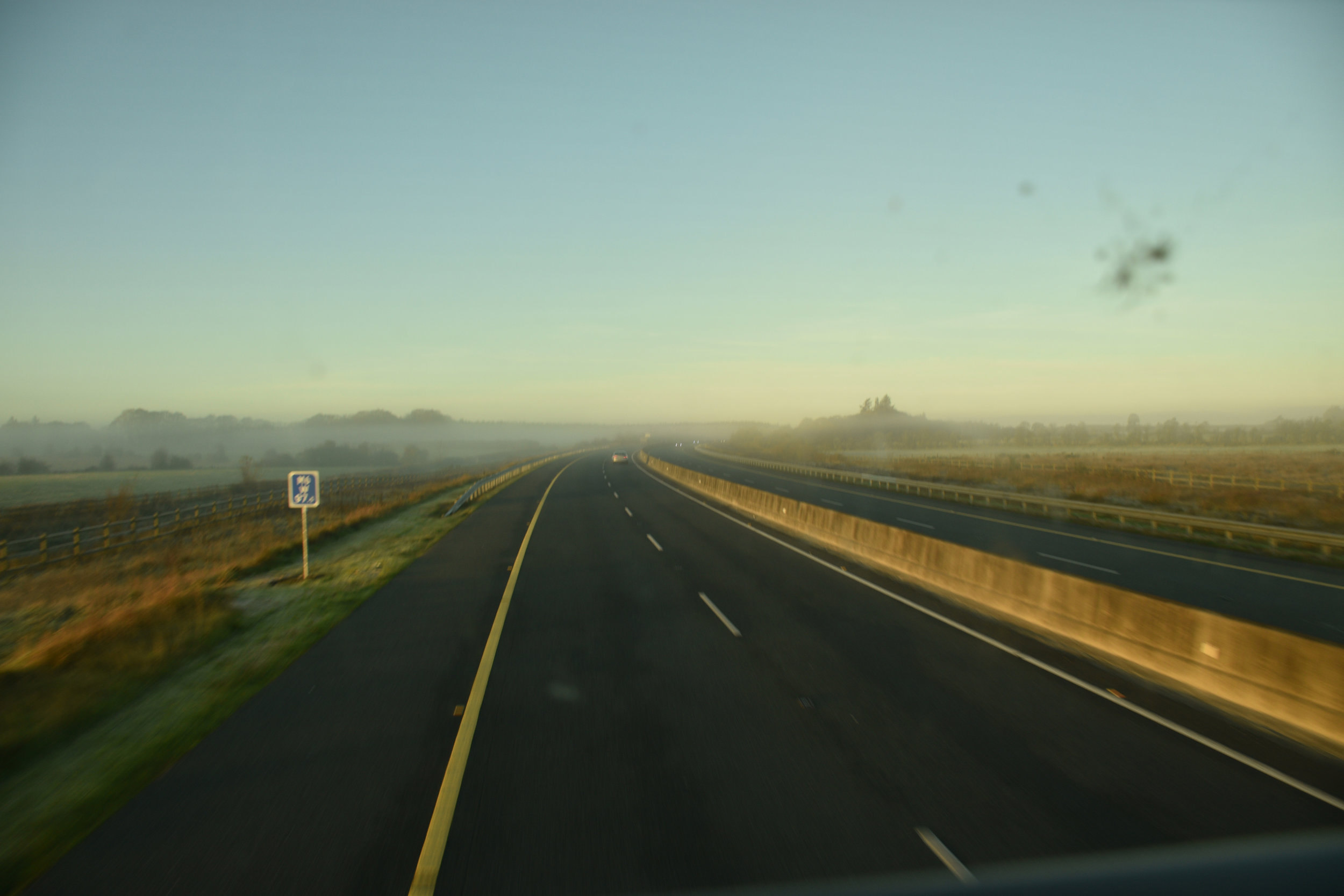 The morning fog surrounds an empty road