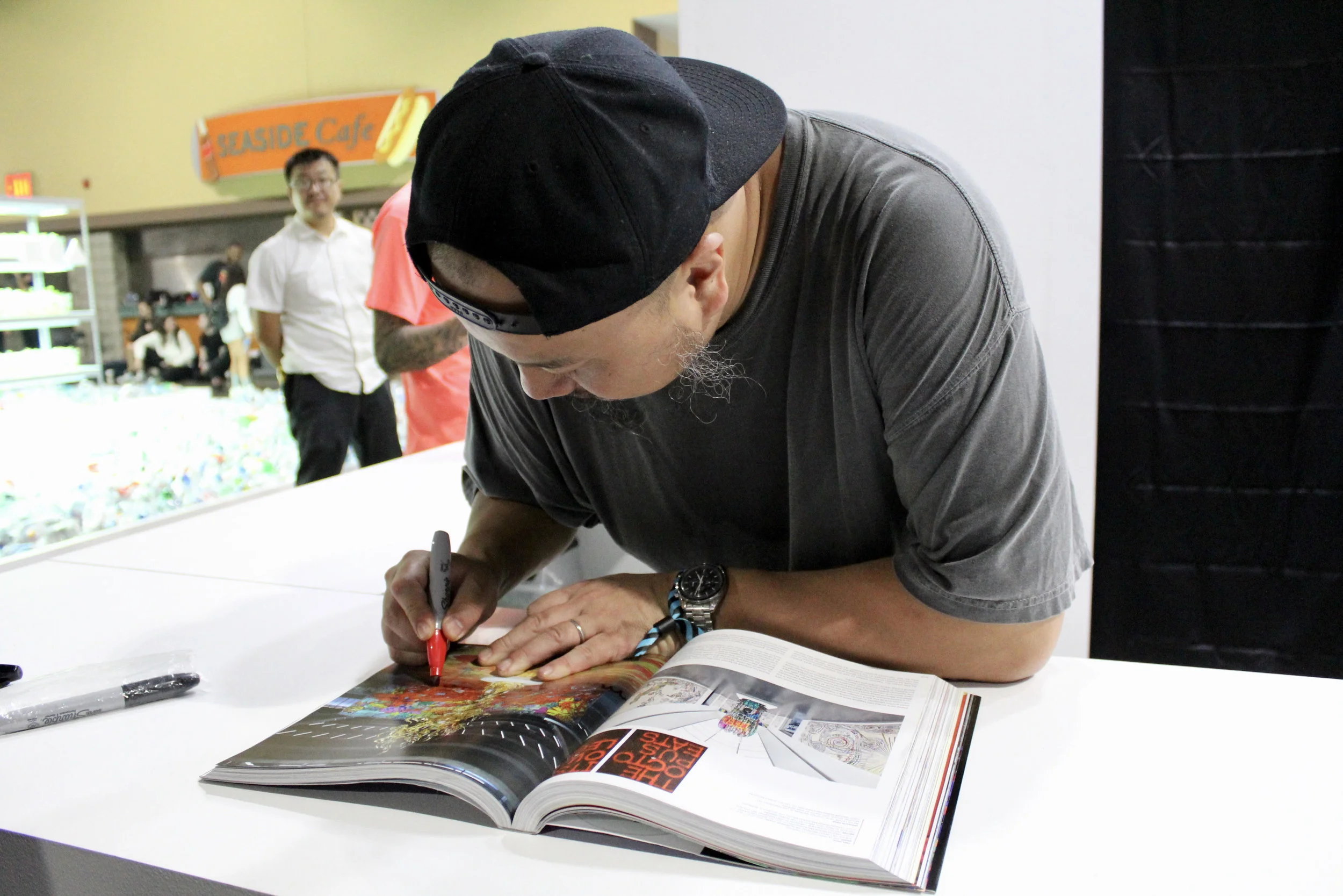 Madsaki signing our Beyond The Streets book at the Kaikai Kiki Gallery booth