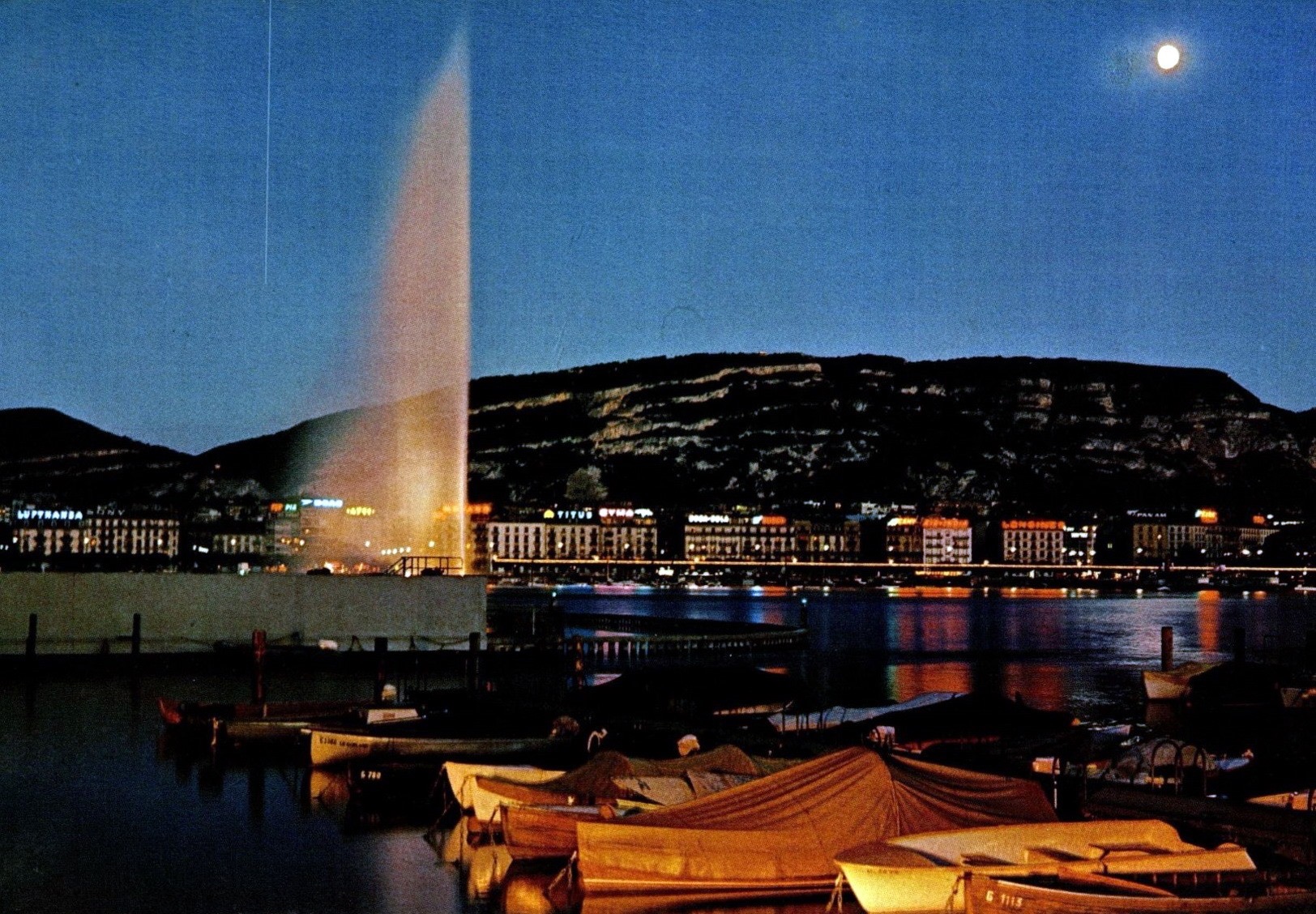 Vintage postcard of Geneva with a view of the Jet d’Eau and the Salève by moonlight.