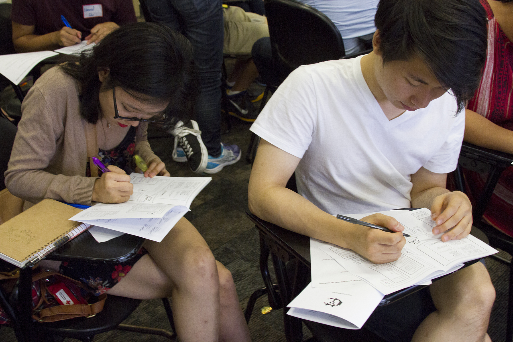 Conference participants filling out surveys.