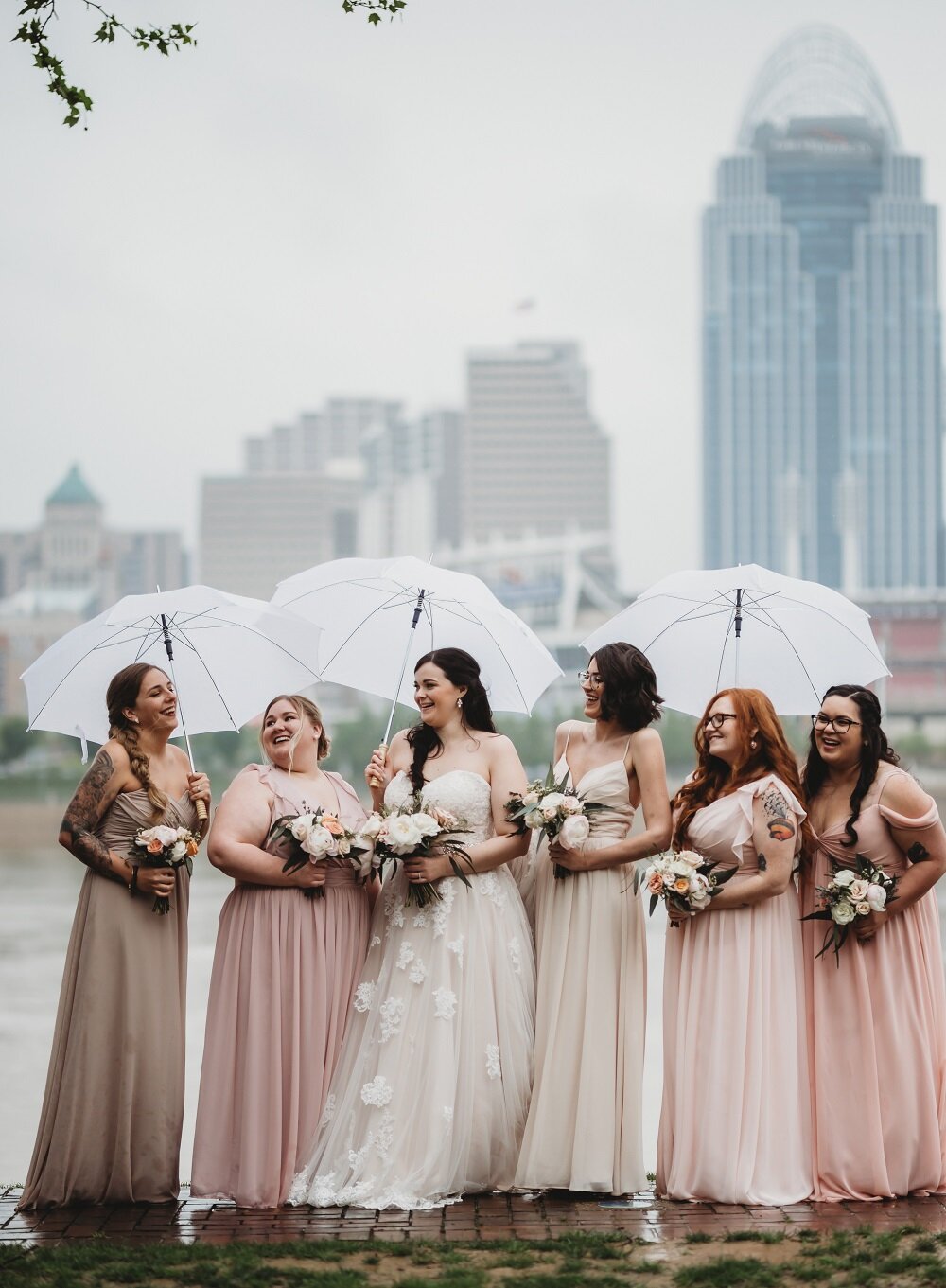 wedding party portraits in front of cincinnati skyline