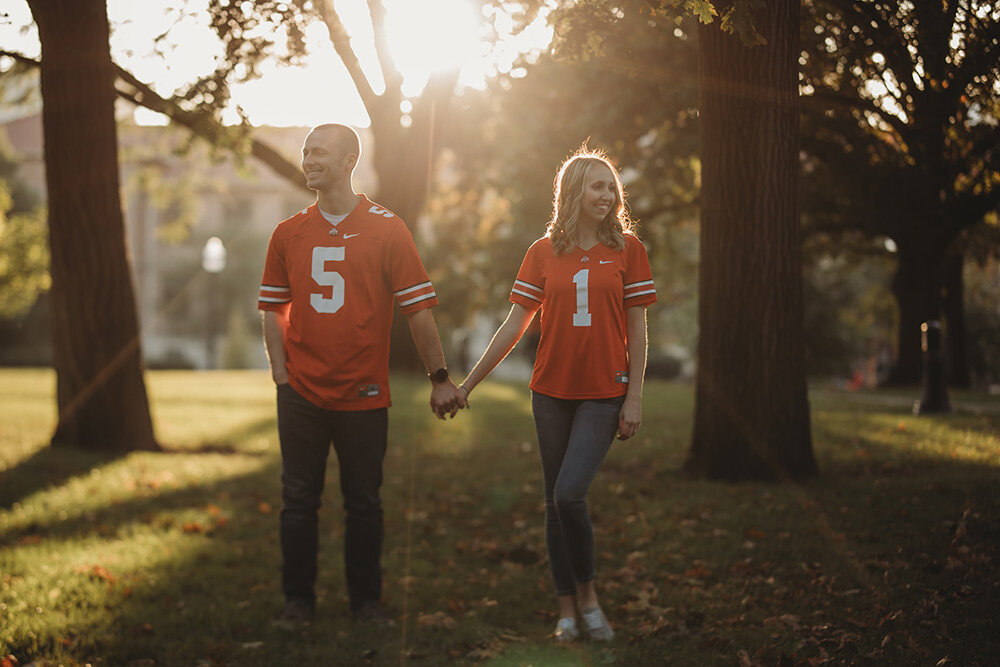 Engagement portraits of couple wearing ohio state university jerseys.