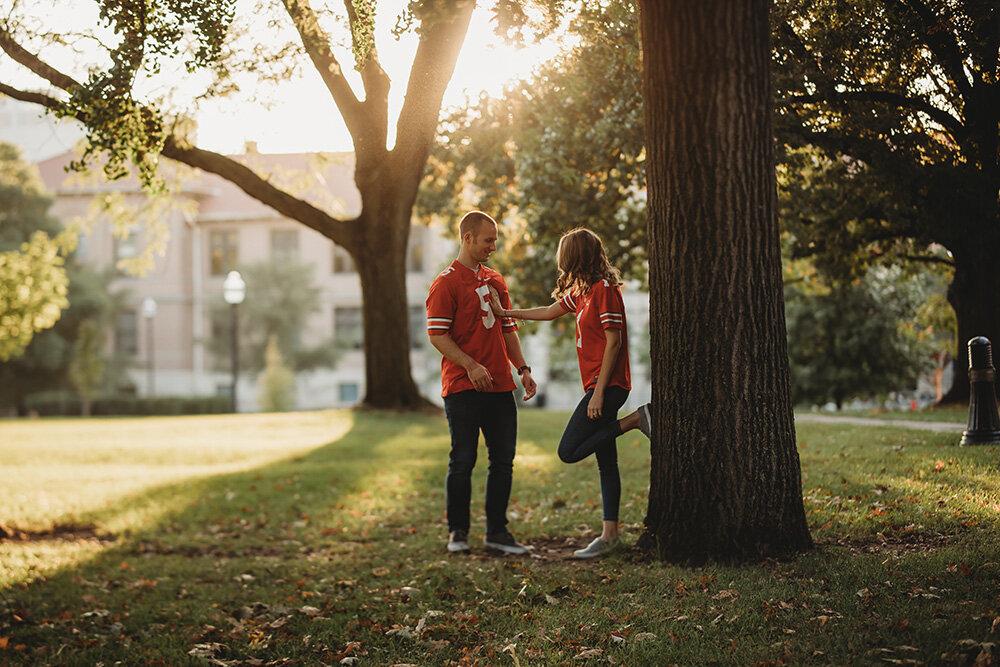 Engagement portraits of couple wearing ohio state university jerseys.