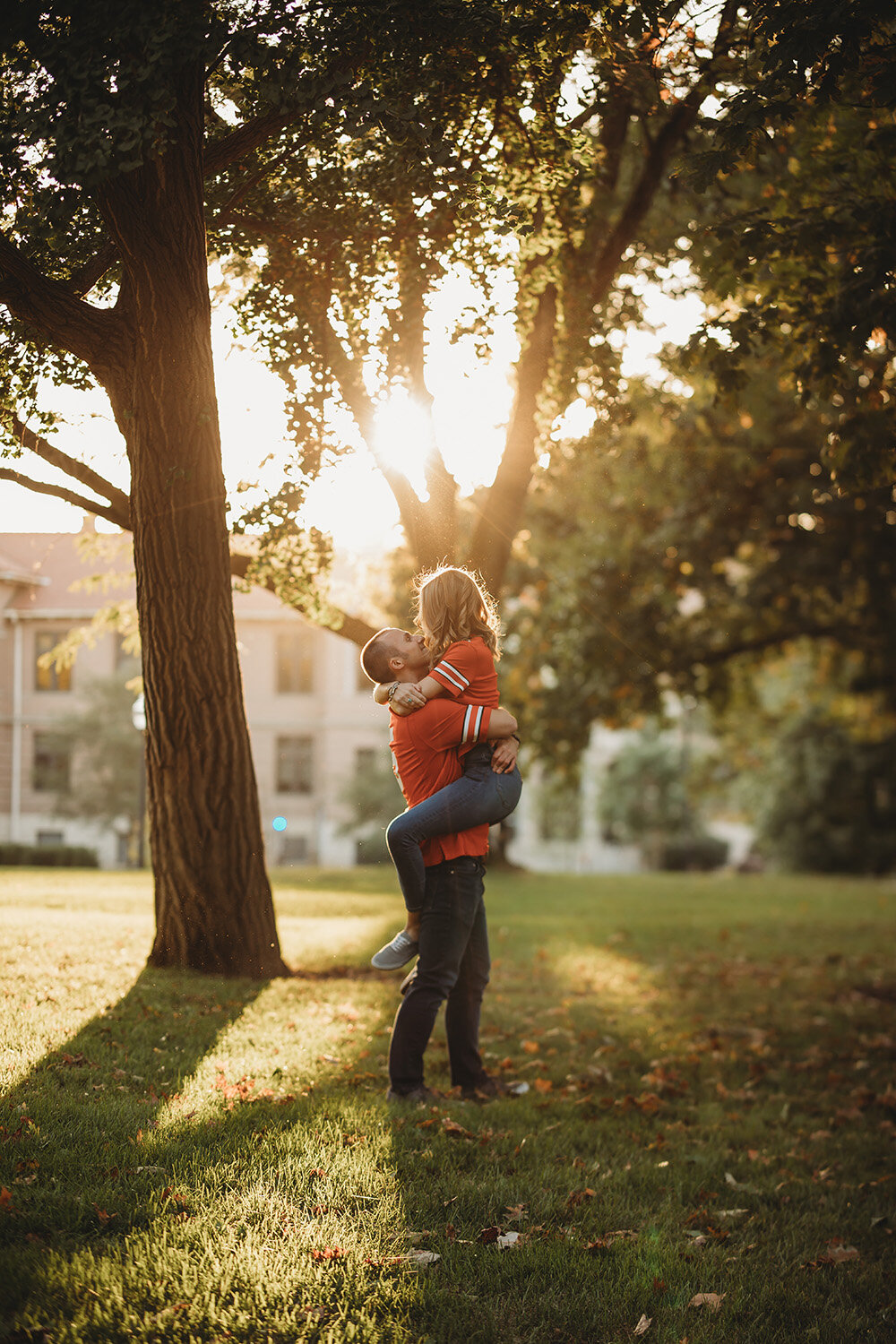 Engagement portraits of couple wearing ohio state university jerseys.