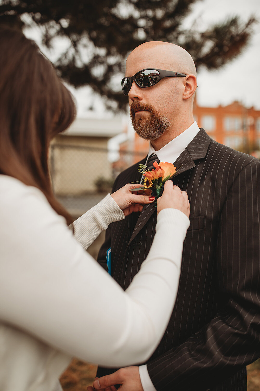 bride helping groom get ready