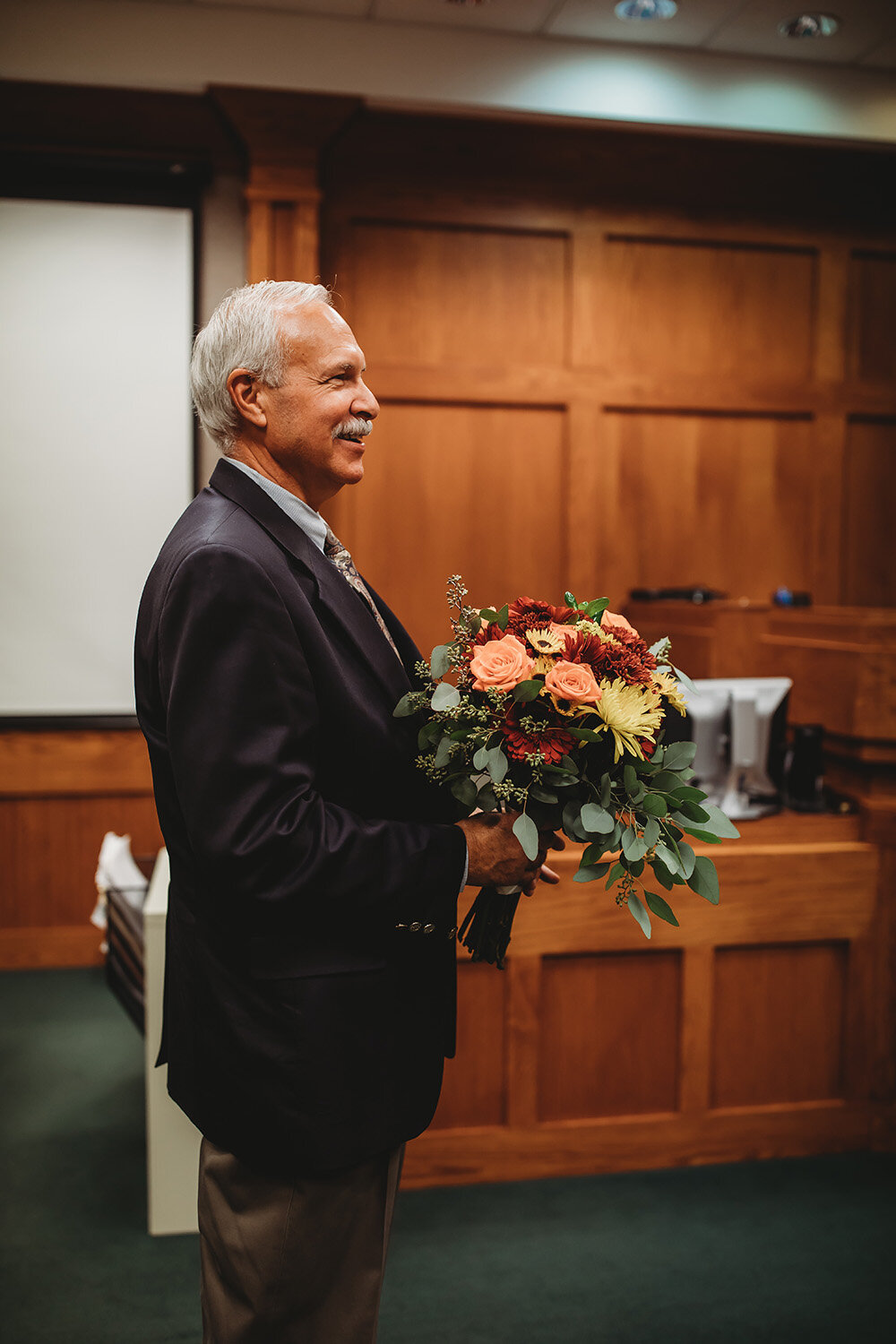 father holding bouquet 