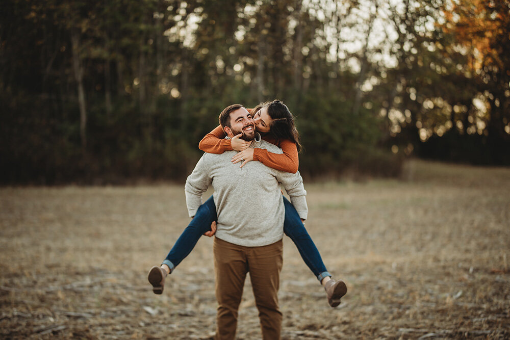 couple giving each other piggyback rides 