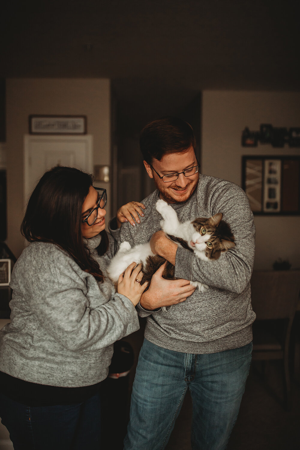 couple holding a cat 