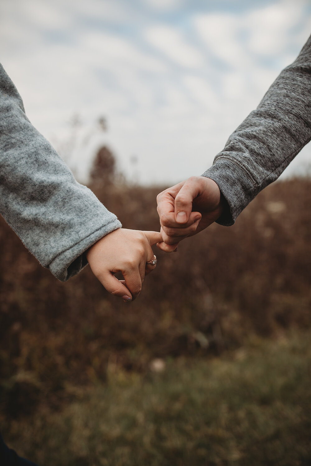 couple pinky promising each other