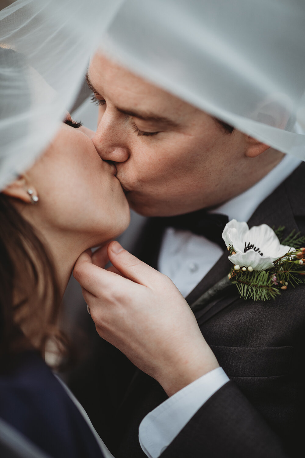 bride and groom share a kiss