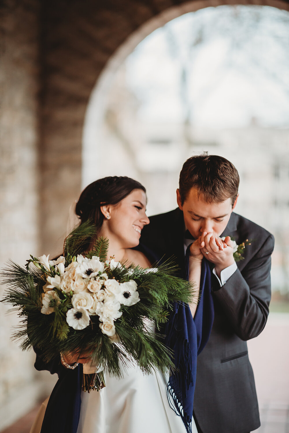groom kissing bride's hand 