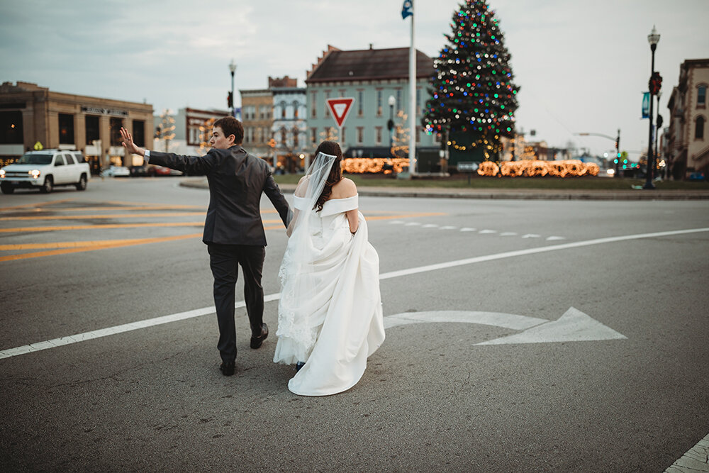 bride and groom crossing the street 