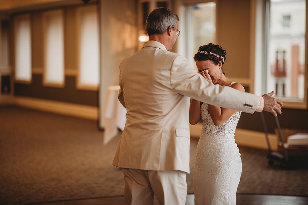 bride sharing first look with father 