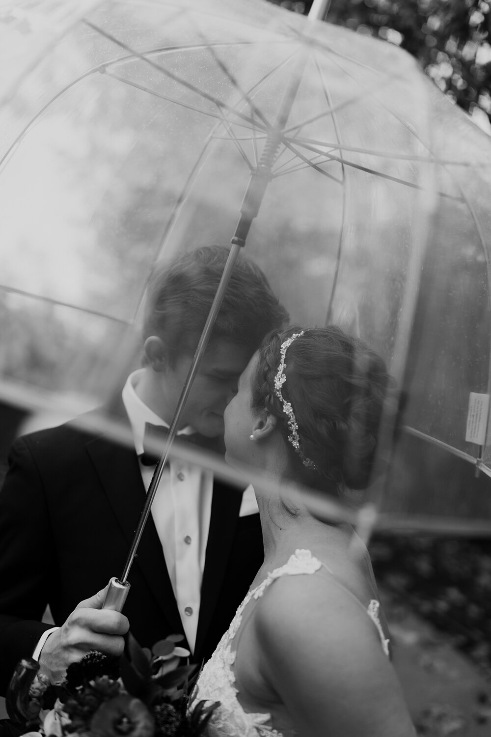 bride and groom portraits under umbrella 